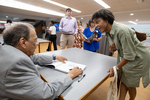 Elizbeth Batte, Ambassador Andrew Young, and Dr. Shawnboda Mead cut the ribbon