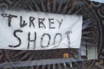 Spray painted "Turkey Shoot" sign by Scott M. Bock
