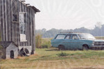 Blue station wagon outside of a an old wooden house by Scott M. Bock