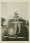 Unidentified woman posed on a car