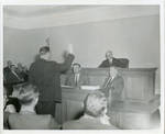 Claude F. Clayton taking oath with Judge Allen Cox presiding. by Author Unknown