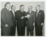 Claude F. Clayton looking at document with John P. Stennis, George Cossar, Hugh Clayton, and unidentified man. by Author Unknown