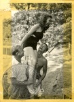Woman on men's shoulders by J. R. Cofield