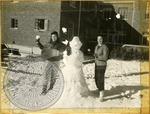 Women building a snowman by J. R. Cofield