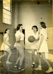Women playing basketball by J. R. Cofield