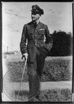 William Faulkner in R.A.F. uniform with cane and cigarette by Unknown