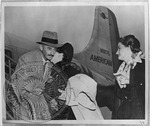 William Faulkner, Estelle, and Jill on plane steps, Memphis, Tennessee. December 6, 1950 by Unknown
