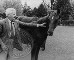 William Faulkner petting his horse, Tempy by Unknown