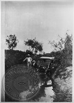 John Westley Thomas Faulkner with car in ditch by Unknown