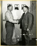 Football coaches Vaught and Drew shaking hands by J. R. Cofield