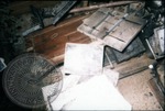Photographs stacked on the ground after the Cofield Studio fire, image 2 by J. R. Cofield
