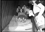 Men push a female student riding a mattress down a staircase by J. R. Cofield