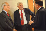 Chancellor Robert Khayat talking to two unidentified men during the 2008 Presidential Debate at the University of Mississippi by Author Unknown