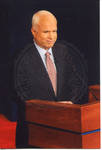John McCain smiling behind a podium on stage at the Ford Center during the 2008 Presidential Debate at the University of Mississippi; 2 copies by Author Unknown