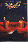 Moderator Jim Lehrer behind desk, John McCain and Barack Obama behind podiums on stage at Ford Center during the 2008 Presidential Debate at the University of Mississippi by Author Unknown