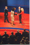 Barack Obama shaking hands with Cindy McCain; John McCain, Michelle Obama and moderator Jim Lehrer standing on stage at the Ford Center during the 2008 Presidential Debate at the University of Mississippi by Author Unknown