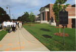 Unidentified guests walking to dedication of the 2008 Presidential debate plaque in front of the Ford Center at the University of Mississippi by Author Unknown