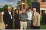 Chancellor Robert Khayat, Dr. Andrew Mullins, Thomas "Sparky" Reardon and an unidentified man and woman in front of the 2008 Presidential debate plaque and Ford Center at the University of Mississippi; 2 copies by Author Unknown