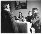 Felton M. Johnston and others at table. by Jim Whitmore and Life