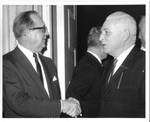 Felton M. Johnston shaking hands at a function. by Author Unknown
