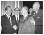 Felton M. Johnston shaking hands at a function. by Author Unknown