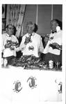 Post-card. Three men standing eating crabs. by Author Unknown