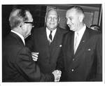 Felton M. Johnston shaking hands with Lyndon Baines Johnson. by Naltchayan