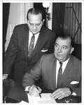 Felton M. Johnston with unidentified man behind desk. by Wide World Photos, Inc. and Associated Press