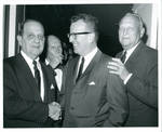 Felton Johnston shaking hands at a function. by Author Unknown