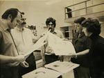 Holding papers by Photographer Unknown