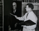 Professor painting a portrait by Photographer Unknown