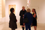 Guests chat at the exhibition by Christina Lutz