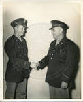 Two military men shaking hands by Author Unknown