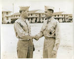 Two men in military uniforms shaking hands by Author Unknown