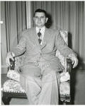 Carroll Gartin seated in chair by Author Unknown