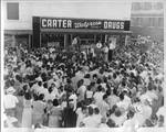 Group of people in front of Carter Drugs by Author Unknown
