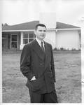 Carroll Gartin standing in front of house by Author Unknown