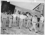 Group of men standing in front of plane by Author Unknown