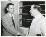 Carroll Gartin shaking hands with unidentified man by Author Unknown