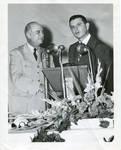 Carroll Gartin at microphone with unidentified man by United States. Air Force