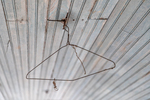 Rusted Hanger Dangles from Porch Beadboard by Thad Lee