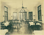 Family-style dining room located in an unknown building, interior by Author Unknown