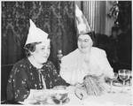 Two women wearing birthday hats. by Jackie Martin