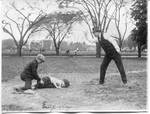 Harrison acting as umpire of boys baseball game. by National Photo