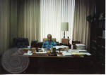 Armis Hawkins seated at desk