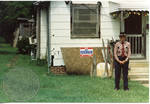 Unidentified man in front of house, image 002