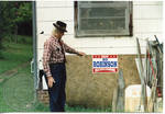 Unidentified man and Bo Robinson campaign sign
