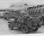 501st Infantry in Army trucks on the football practice field by Edward Movitz
