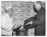 Eastland with Walter H. (Skeet) Hunt as he prepares shrimp for Congressional members. by International News