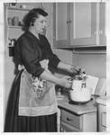 Mrs. Eastland baking devil's food cake. by Author Unknown